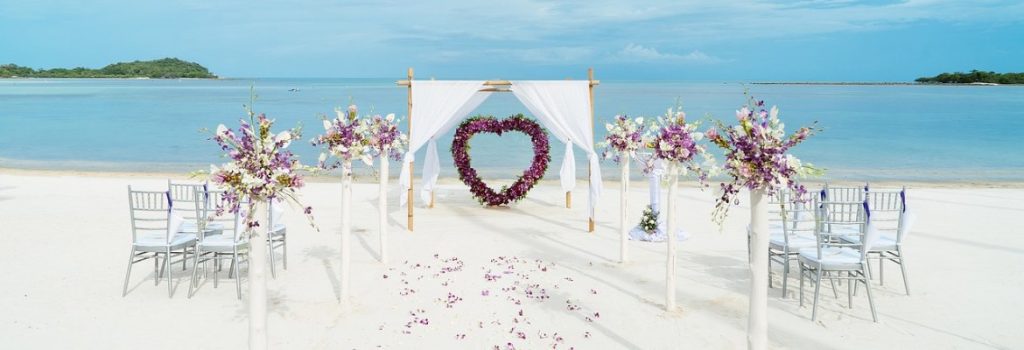 Beach wedding showing an alter, chairs and a view of the ocean on white sand